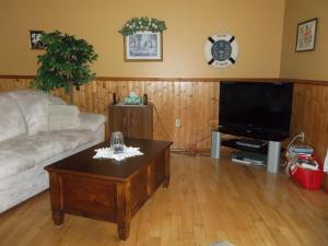 a living room with a couch and a coffee table at Gulliver's Cove Oceanview Cottages in Centreville