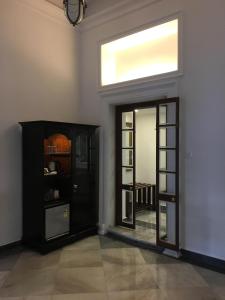 a room with a black door and a window at The Harrington Residency in Kolkata