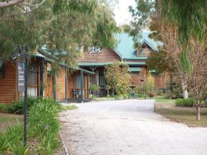 a house with a street sign in front of it at Cottages on Edward in Deniliquin