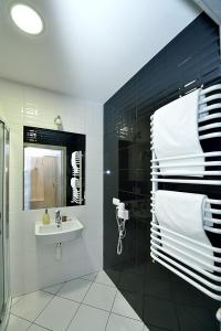 a bathroom with a sink and a mirror and towels at Nova Stodola in Kłomnice