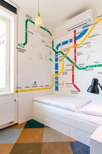 a bedroom with a subway map on the wall at MeetMe23 in Prague