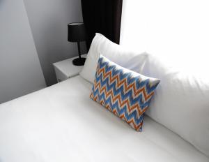 a white bed with a pillow sitting on top of it at Bayer Hotel in Istanbul