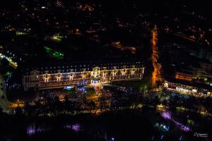 a view of a building at night with lights at Hôtel Barrière Le Westminster in Le Touquet-Paris-Plage