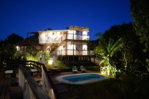 a large house with a swimming pool in front of it at Malta Homestay in José Ignacio