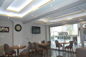 a dining room with tables and chairs and a window at Göznur Otel in Bandırma