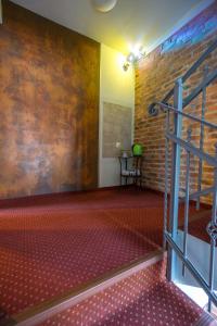 a room with a staircase and a brick wall at Relaks in Szklarska Poręba