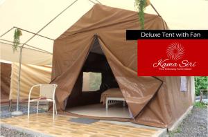 a large tent with a chair and a red sign at Kama Siri Koh Kood in Ko Kood