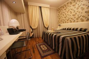 Postel nebo postele na pokoji v ubytování Phi Hotel Principe