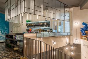 a bar in a restaurant with a glass wall at MeetMe23 in Prague
