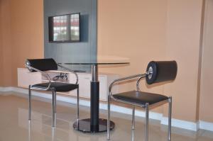 a glass table and two chairs in a room at RL Veranda Suite in Baguio