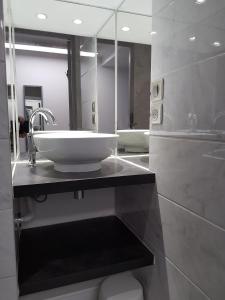 a bathroom with a sink and a mirror at Terres de France - Résidence les Silènes in Allevard