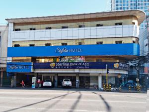 a building with a sign for a hotel at Skyblue Hotel in Cebu City