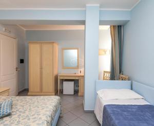 レ・カステッラにあるVilla Auroraのベッド2台とデスクが備わるホテルルームです。