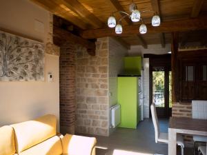 a living room with a couch and a table at Apartamentos La Fabrica in Villaluenga de la Vega