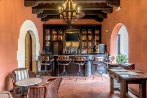 a bar in a room with chairs and tables at Hodelpa Nicolás de Ovando in Santo Domingo