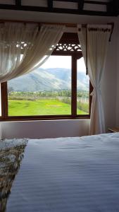 a bedroom with a bed and a window with a view at Cabañas Sol y Luna in Villa de Leyva