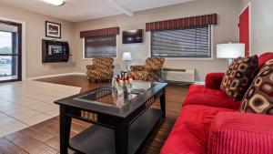 a living room with a red couch and a table at Best Western Paris Inn in Paris