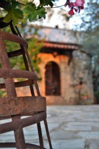 a wooden chair sitting in front of a building at Fattoria La Tana della Volpe in Pacentro