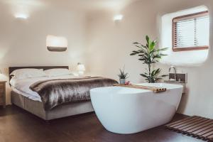 a bedroom with a bed and a bath tub at The Little Fish in Cockermouth