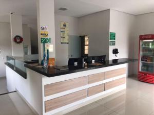 a restaurant counter with a black counter top at Rota Hoteis Uberlandia in Uberlândia