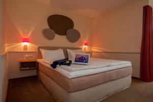 
Ein Bett oder Betten in einem Zimmer der Unterkunft Landhotel Broda
