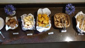a bunch of baskets of food on a table at Pousada Spa Prana Lorien in Santo Antônio do Leite