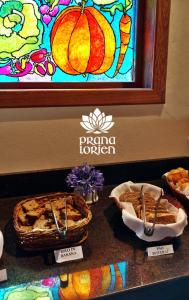 a table topped with pies and a stained glass window at Pousada Spa Prana Lorien in Santo Antônio do Leite