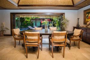 a dining room with a table and chairs at Te Manava Luxury Villas & Spa in Rarotonga