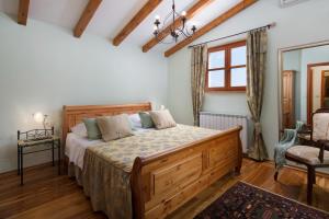 a bedroom with a bed and a chair and a window at Villa Primela**** in Labin +32 photos