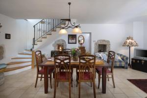 a dining room with a wooden table and chairs at Villa Primela**** in Labin