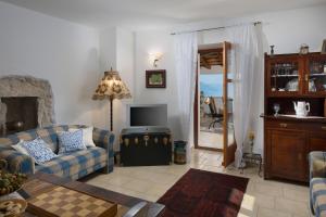 a living room with a couch and a television at Villa Primela**** in Labin