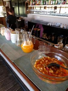 a counter with a bowl of food and orange juice at Casa Suaya in José Ignacio