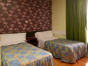 Posteľ alebo postele v izbe v ubytovaní Hostal Padre Isla 1