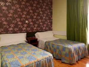 Posteľ alebo postele v izbe v ubytovaní Hostal Padre Isla 1