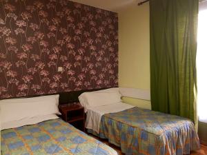 Posteľ alebo postele v izbe v ubytovaní Hostal Padre Isla 1