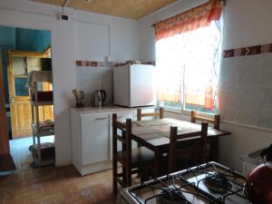 a kitchen with a table and a stove in it at Cabañas Akiko in Hanga Roa