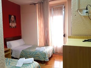 Posteľ alebo postele v izbe v ubytovaní Hostal Padre Isla 1