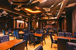 a dining room with wooden tables and chairs at Tasik Villa International Resort in Port Dickson