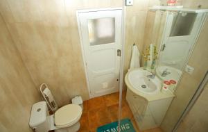 a small bathroom with a toilet and a sink at Casinha da Aldeia in Melides +42 photos