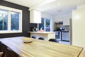 a kitchen with a wooden table in a room at JstLikeHome - Getaway in Ottawa