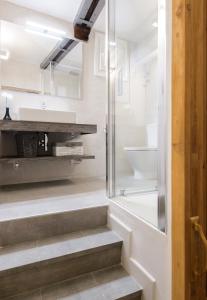 a bathroom with stairs and a shower and a toilet at Charming Madrid Center - Estancias Temporales in Madrid