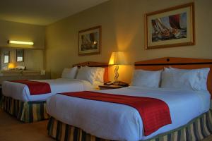 a hotel room with two beds in a room at Holiday Inn Hotel & Suites Osoyoos, an IHG Hotel in Osoyoos