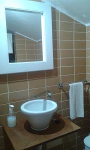 a bathroom with a sink and a mirror at Valmoa in Praia da Vitória +16 photos