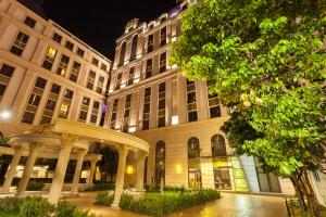 a building with a pavilion in front of it at night at Golden Tulip - Aesthetics in Zhunan