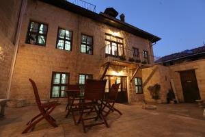 a patio with chairs and a table in front of a building at Ali Bey Konagi in Gaziantep