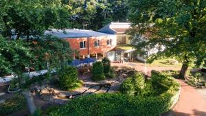 an aerial view of a house with trees and bushes at Ostel Jugendhotel Bremervörde in Bremervörde