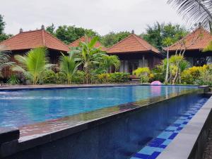 a swimming pool in front of a villa at Kencana Garden in Nusa Lembongan