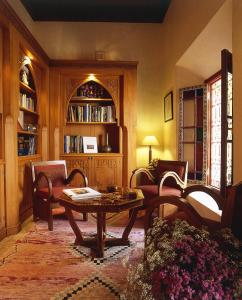 a living room with a table and chairs at Riyad Al Moussika in Marrakesh
