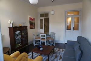 a living room with a blue couch and a table at Baixa Apartamento in Bragança