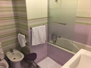 a bathroom with a sink and a toilet and a shower at Praia de Mira in Praia de Mira +33 photos